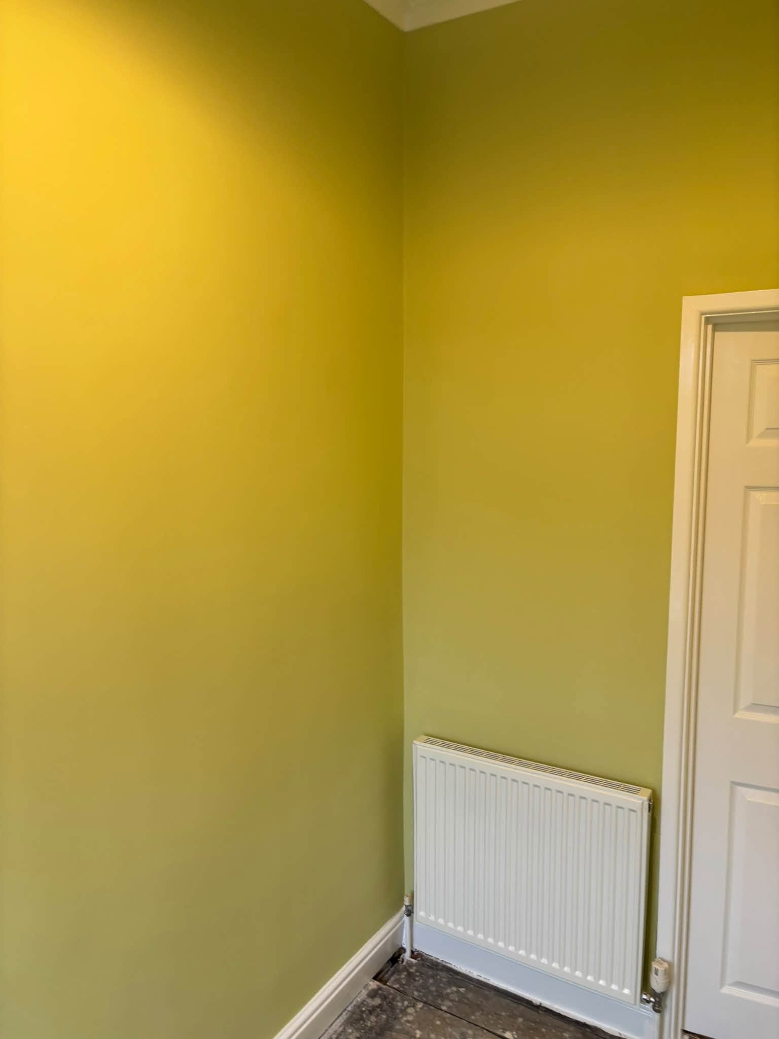 Freshly painted yellow-green room with white woodwork