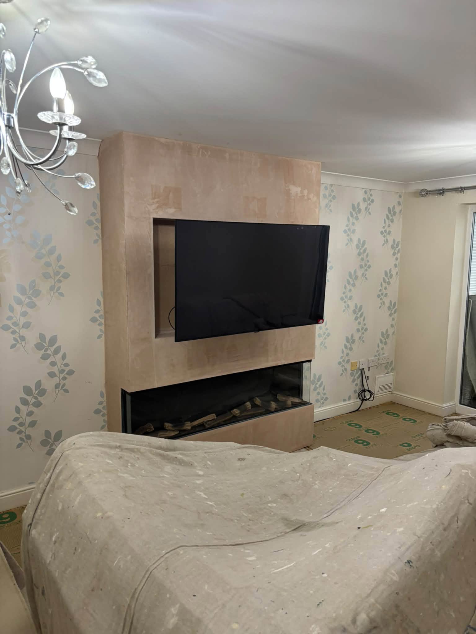 Decorative wallpaper and living room fireplace detail